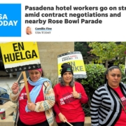 Masthead of USA Today with photo of three women in red shirts holding picket signs that say "On Strike" and "En Huelga" in black text on a yellow background