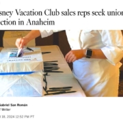 Headline reading "Disney Vacation Club sales reps seek union election in Anaheim" over a photo showing someone from the shoulders down who is putting a paper in a Local 11 ballot box.