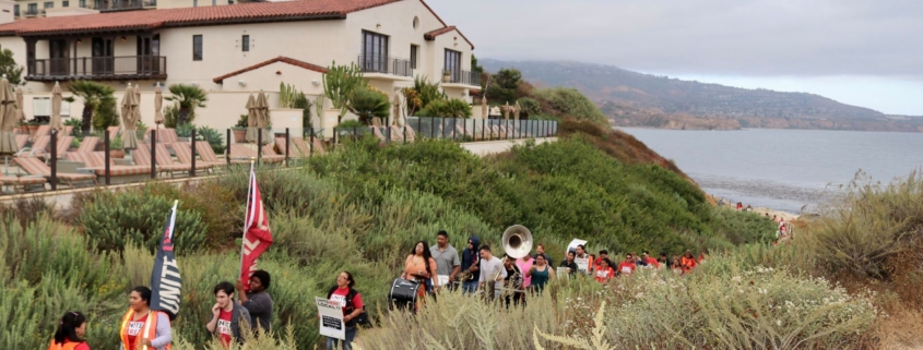 Local 11 worker leaders march through protected coastal access near the non-union Terranea Resort in 2019