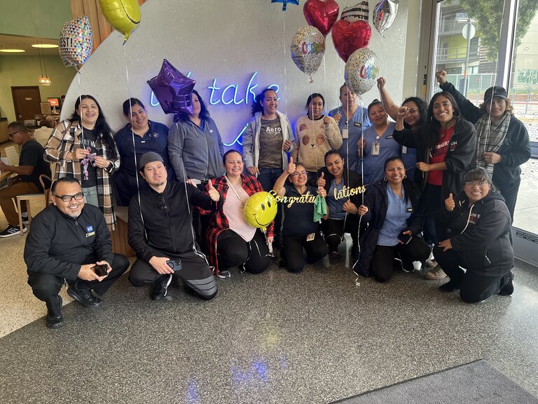 Hotel workers gather with balloons at the Hampton Inn Santa Monica